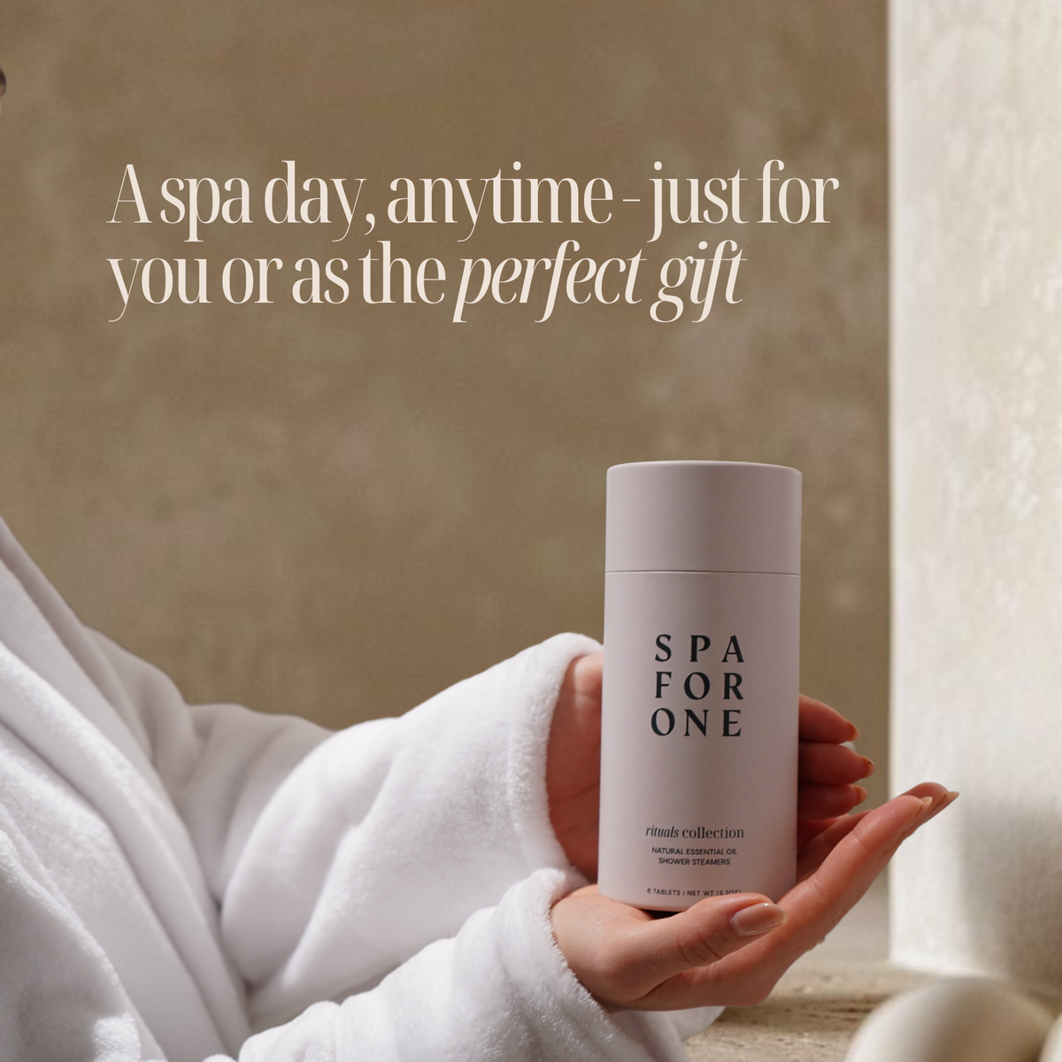Person holding the spa for one rituals collection shower steamers with the text "A spa day, anytime - just for you or as the perfect gift.